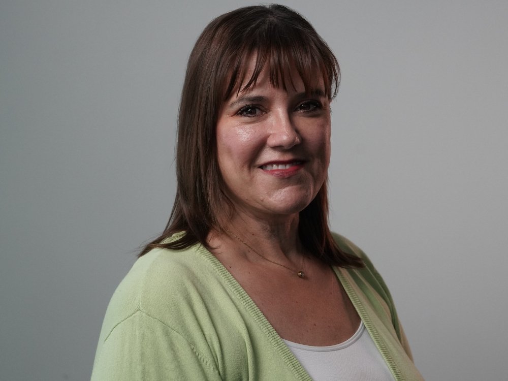 Smiling woman in a light green cardigan portrait