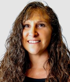 Portrait of smiling woman with long curly brown hair